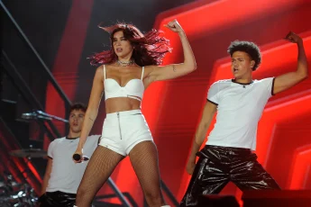 Dua Lipa during a concert - also in white shorts