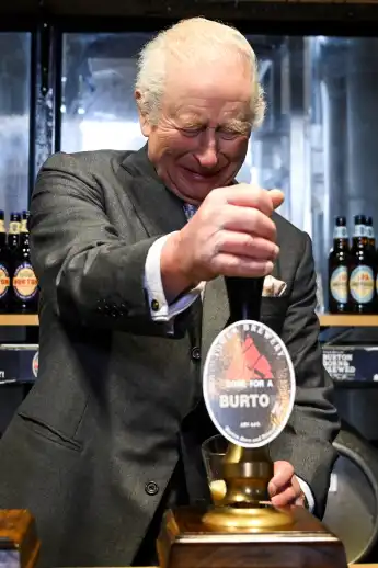King Charles tapping beer