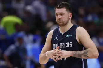 Luka Dončić tattoo tattoos left arm forearm Doncic closeup eagle tiger eye of god latin quote palm leaves number