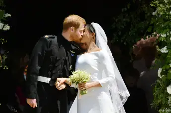 Prince Harry and Meghan Markle kiss on the steps of St George's Chapel in Windsor Castle after their wedding in St George's Chapel at Windsor Castle on May 19, 2018.