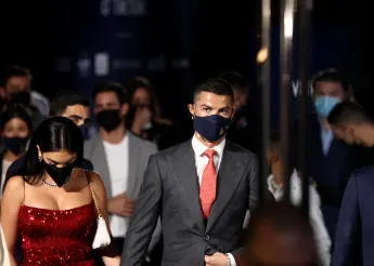 Cristiano Ronaldo in a suit and Georgina Rodriguez in a red glitter dress go to an event together