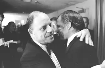 Singer  Frank  Sinatra  hugs  Don  Rickles  backstage  during  his  farewell  performance  at  UCLA