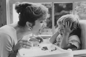 TV  talk  show  cohost  Kathie  Lee  Gifford  facing  her  2-yr-old  son  Cody  as  he  sits  in  hi