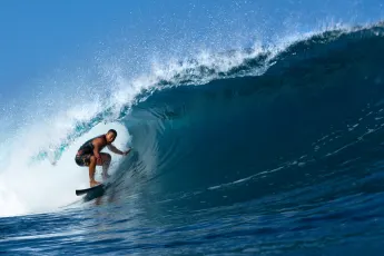 Tamayo Perry Surfing the Tube at Pipeline, Hawaii, Pro surfer, Tamayo Perry, rides a blue,tubing, wave while surfing at