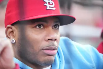 Rapper Nelly watches the scoreboard during the Los Angeles Dodgers-St. Louis Cardinals baseball game at Busch Stadium in