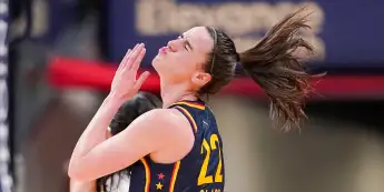 Syndication: The Indianapolis Star Indiana Fever guard Caitlin Clark (22) throws her head back after getting hit in the