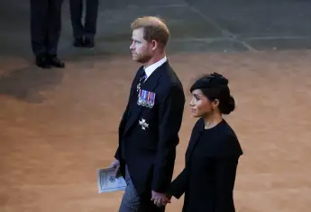 Duchess Meghan and Prince Harry hold hands