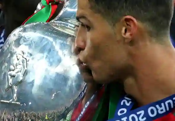 SAINT DENIS FRANCE JULY 10 2016 Portugal s Cristiano Ronaldo kisses the trophy after winning th