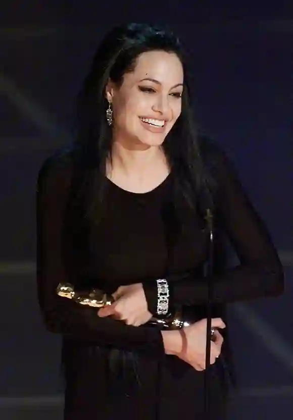 Angelina Jolie holds her Oscar for Best Performanc