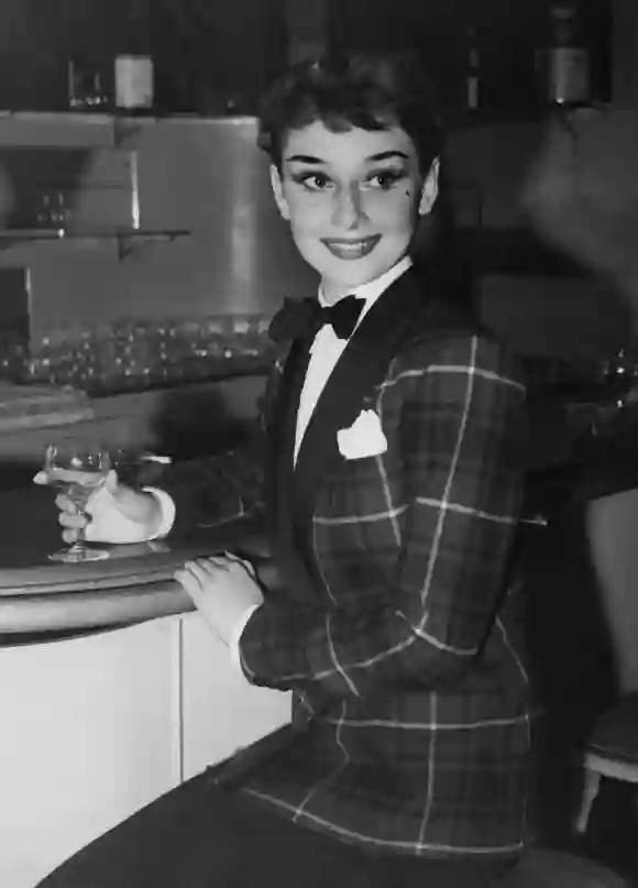 Actress Audrey Hepburn (1929 - 1993) dines out in London's West End, wearing a tartan jacket and bow tie, 3rd October 1950.