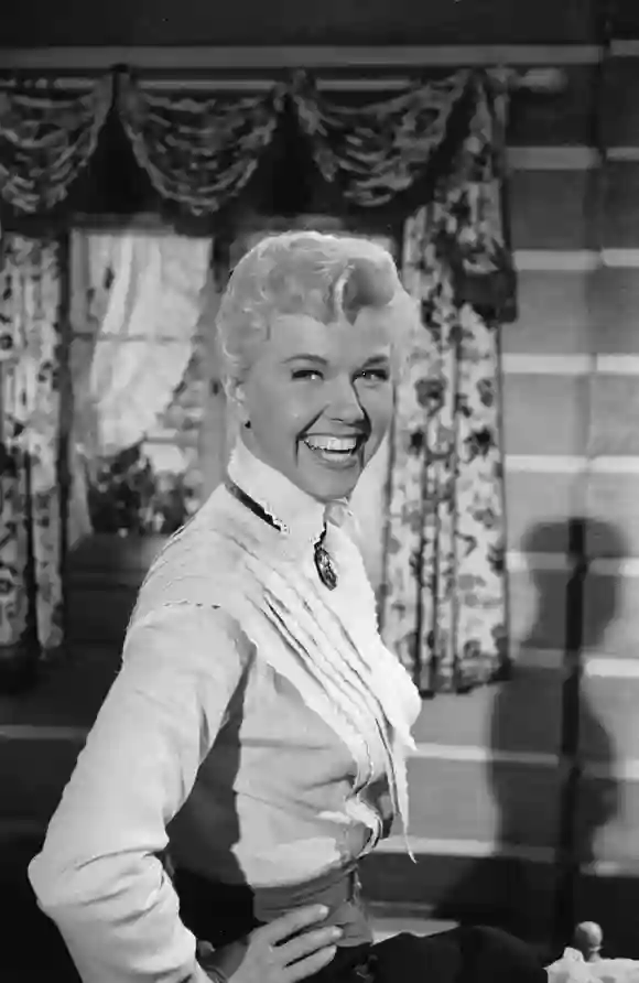 American  actress  and  singer  Doris  Day  laughs  with  her  hands  on  her  hips  while  on  set