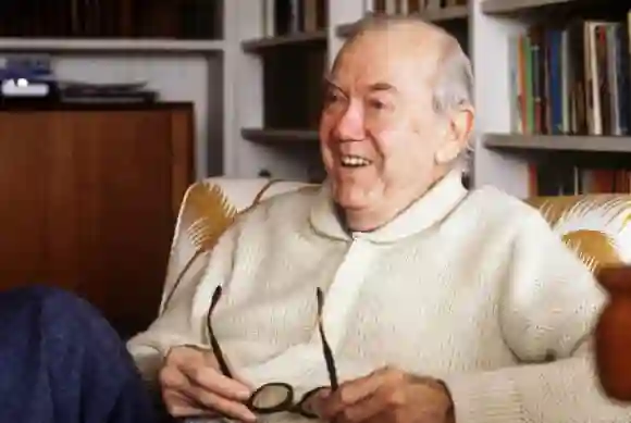 British writer Graham Greene (1904-91) at his home