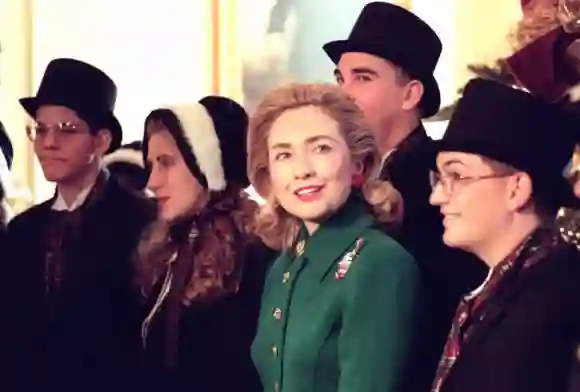 First Lady Hillary Clinton poses with traditional Christmas carolers in the East Room of the White House