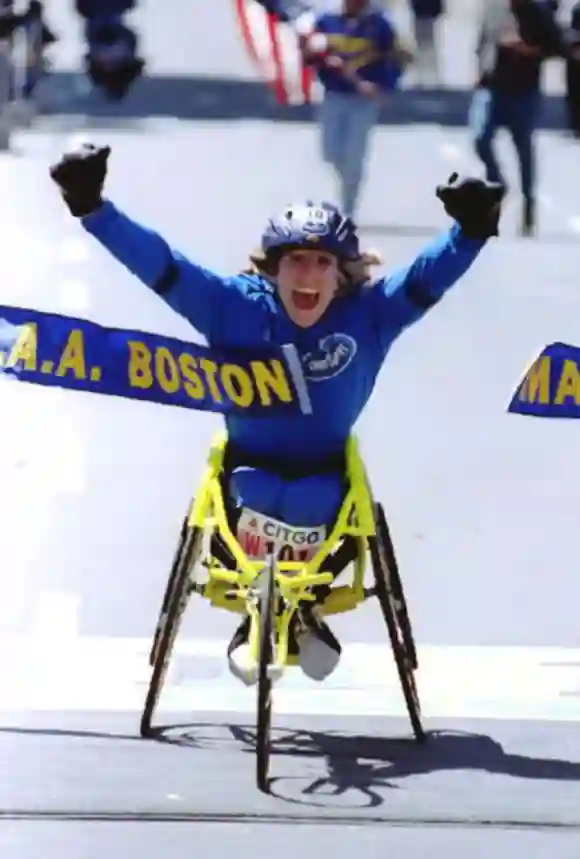 Jean Driscoll of the US reacts as she crosses the