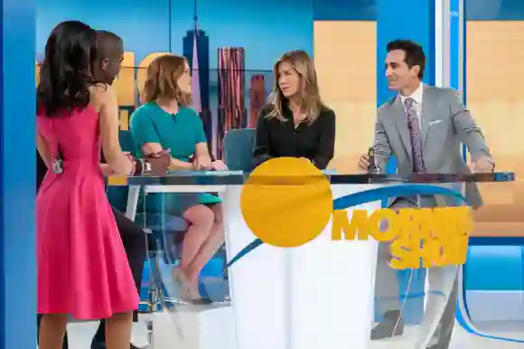 THE MORNING SHOW, from left: Janina Gavankar (back to camera), Desean K. Terry (obscured), Reese Witherspoon, Jennifer A