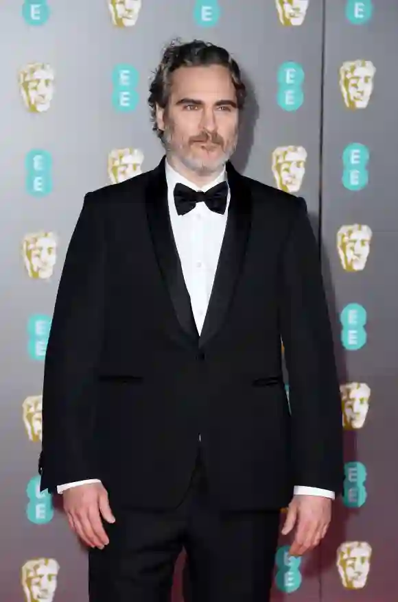 Joaquin Phoenix poses on the red carpet at the BAFTAs on February 2, 2020.