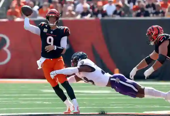 Le quarterback des Cincinnati Bengals Joe Burrow (9) lance sous la pression des Baltimore Ravens Trenton Simpson (23) pendant le match.