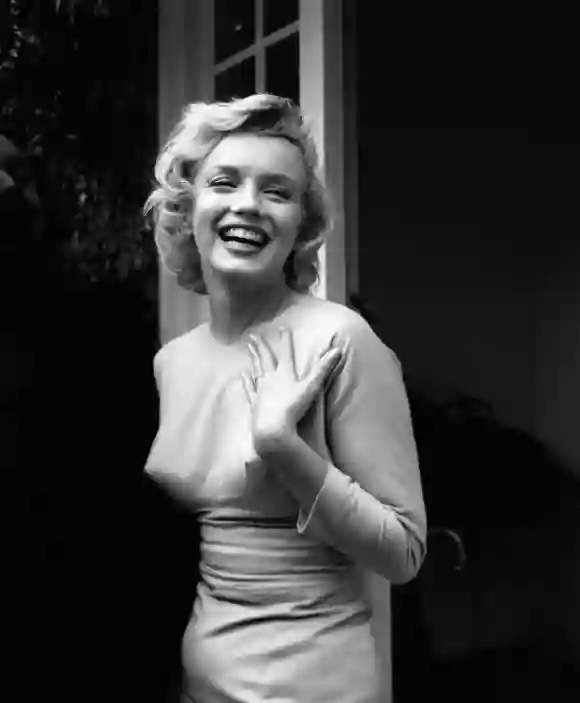 American film star Marilyn Monroe (1926 - 1962) outside her home at Englefield Green