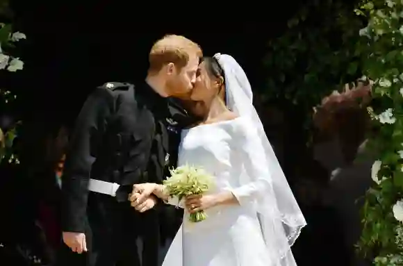 Prince Harry and Meghan Markle kiss on the steps of St George's Chapel in Windsor Castle after their wedding in St George's Chapel at Windsor Castle on May 19, 2018.