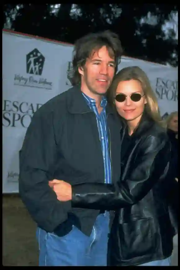 Actress  Michelle  Pfeiffer  w.  arms  around  producer  husband  David  E.  Kelley  at  Children  a