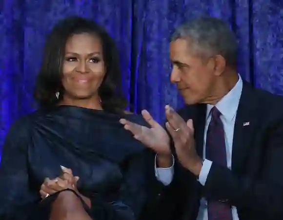 Former U.S. President Barack Obama and first lady Michelle Obama participate in the unveiling of their official portraits.