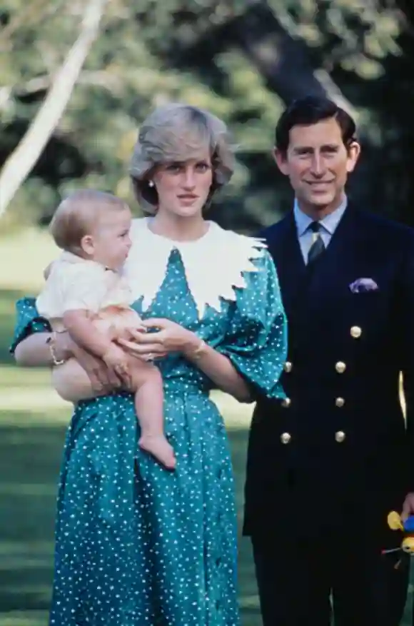 Prince Charles and Princess Diana, wearing a green dress with white polka dots and a white puritan collar, pose with their baby son, Prince William, in the gardens of Government House in Auckland, New Zealand, on April 23rd, 1983. (Photo by Hulton Archive/Getty Images)