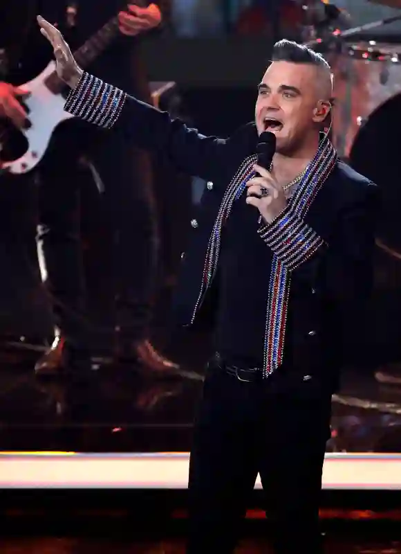 Robbie Williams performs onstage during the Ein Herz Fuer Kinder Gala show at Studio Berlin Adlershof on December 7, 2019 in Berlin, Germany