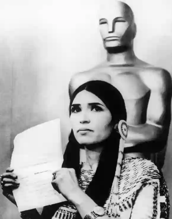 Sacheen Littlefeather holds a written statement from actor Marlon Brando refusing his Best Actor Oscar on stage at the Academy Awards