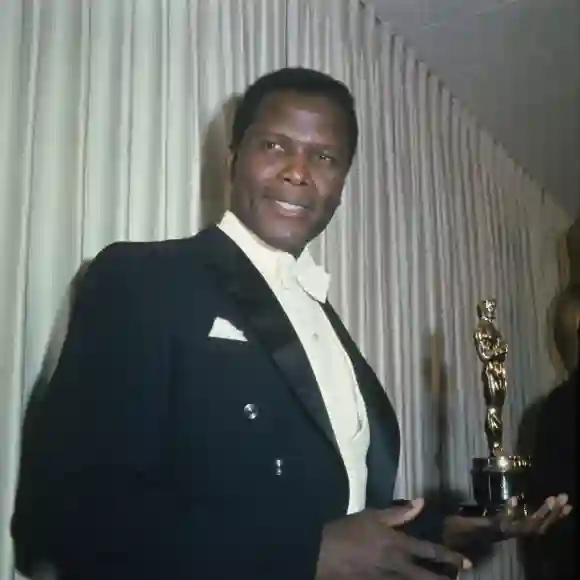 Bahamian American actor Sidney Poitier holding his Academy Award for Best Actor in a Leading Role in 1964