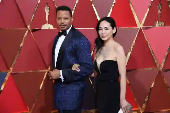 Terrence Howard and Mira Pak pose as they arrive on the red carpet for the 89th Oscars