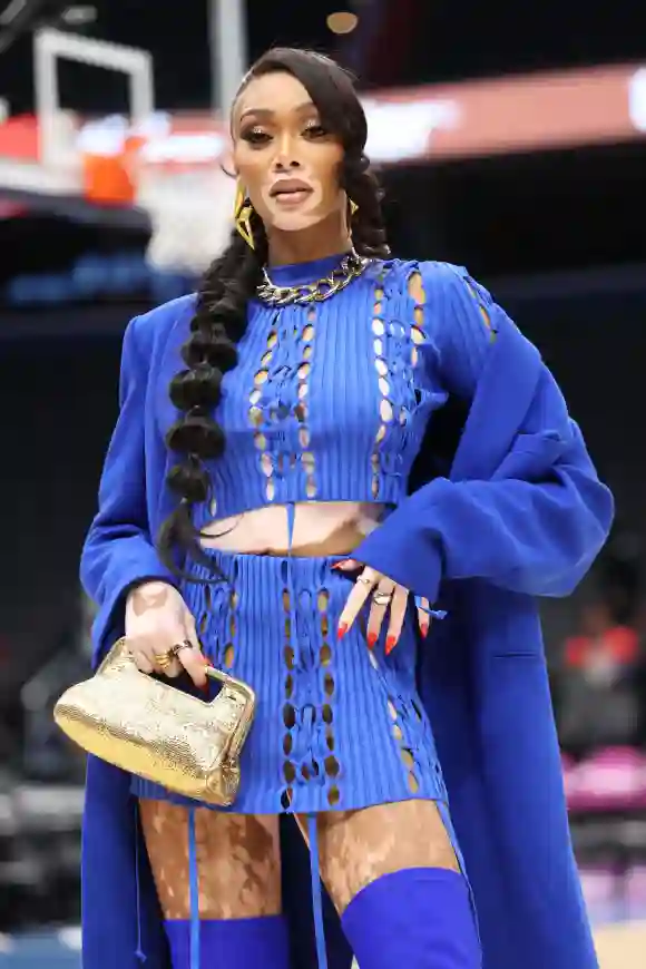 Winnie Harlow holds a commemorative ball honoring the Wizards 25th year at the Washington Wizards vs Phoenix Suns NBA Ga