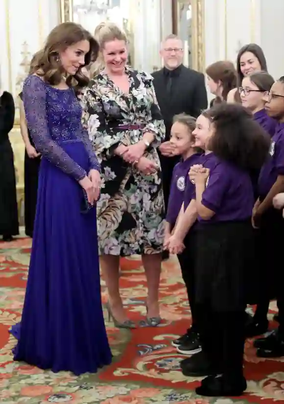 Duchess Catherine speaking to a school choir at Buckingham Palace on Monday evening.