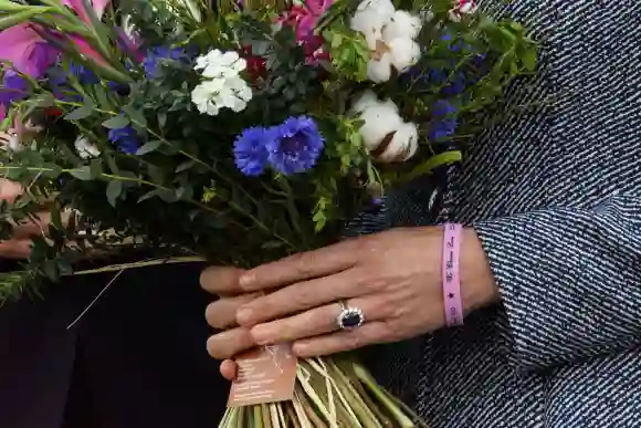 Catherine, Duchess of Cambridge holds a posy of flowers as she leaves after attending the official opening of the Glade of Light memorial, May 10, 2022.