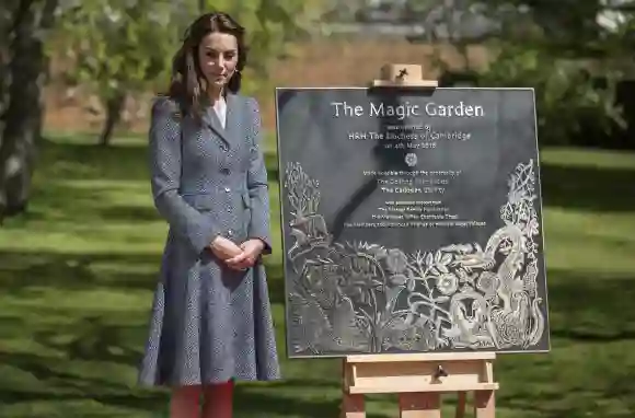 Catherine, Duchess of Cambridge stands with the plaque she unveiled as she officially opens The Magic Garden, May 4, 2016.