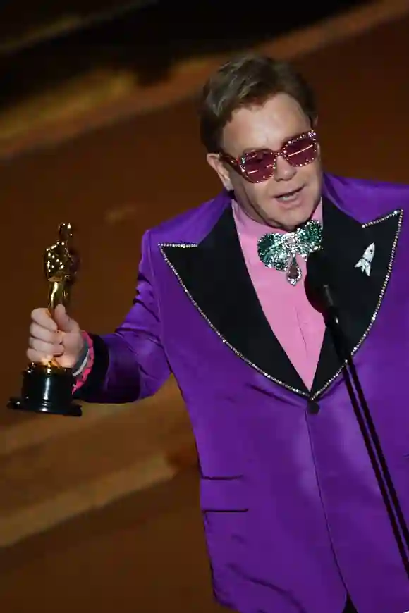 Elton John accepts his award