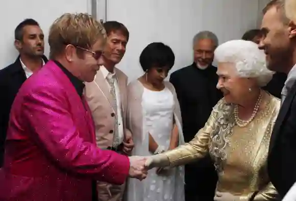 La reina Isabel II es presentada a Sir Elton John por Gary Barlow tras el Jubileo de Diamante, Concierto en el Palacio de Buckingham, el 4 de junio de 2012.