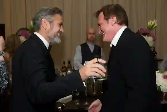 Producer, George Clooney, Oscar winner for best picture for Argo congratulates Quentin Tarantino, Oscar winner for origi