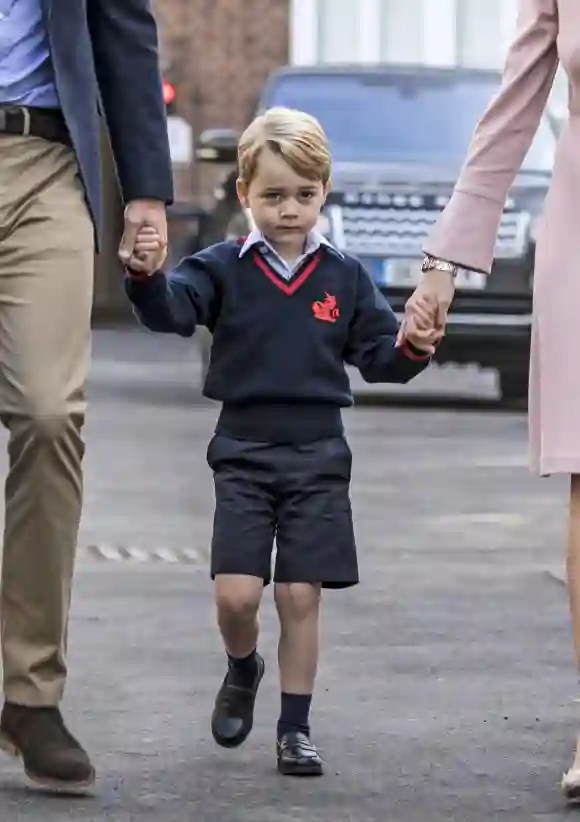 PAP09171777 Prince George holding the hand of his father Prince William Duke of Cambridge arrives