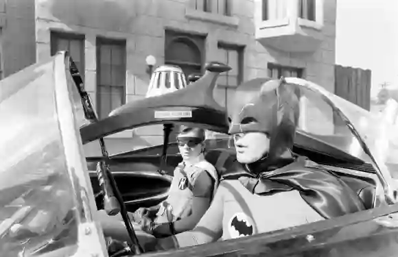 Adam West (R) 'Batman' and 'Robin' Burt Ward (L) riding the Bat-Mobile, California, United States, 1