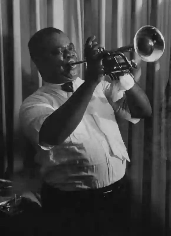 Musician  Louis  Armstrong,  playing  his  trumpet  on  the  Jackie  Gleason  T.V.  program.Leonar