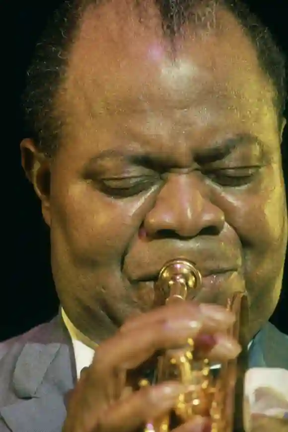 Close-up  of  American  jazz  musician  Louis  Armstrong  (1901  -  1971)  as  he  plays  trumpet,