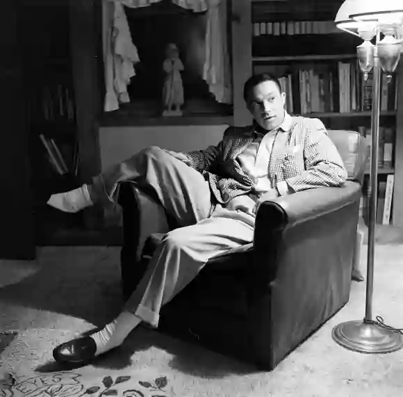 Gene  Kelly  sitting  on  a  couch  in  a  room,  United  States,  November  1959j  r  Eyerman/The