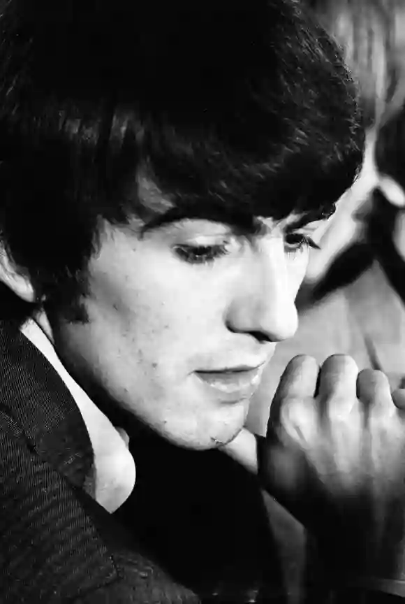 George Harrison, a member of the music group The Beatles, during an interview after the group arrive