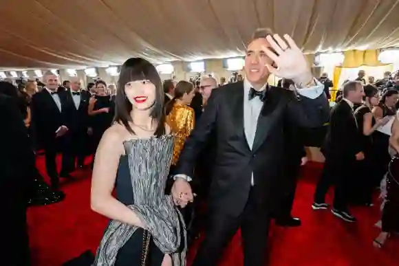 Riko Shibata and Nicolas Cage arrive on the red carpet of the 96th Oscars® at the Dolby® Theatre at Ovation Hollywood