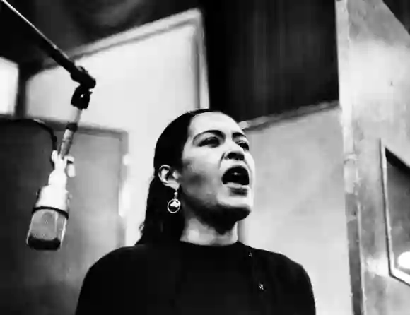 BILLIE HOLIDAY (1915-1959). American jazz singer and songwriter. Photographed during a recording session, probably 1940s