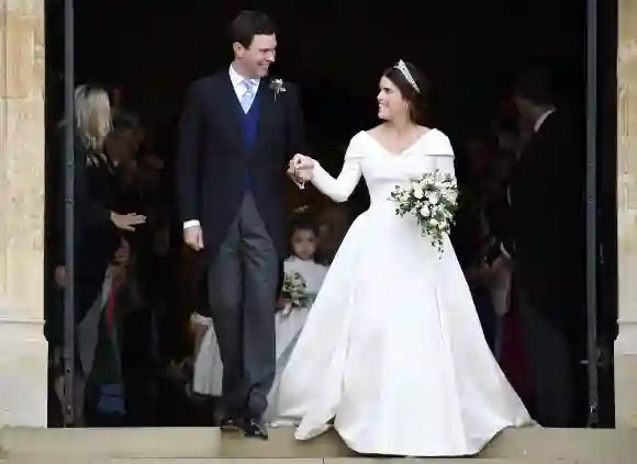 Jack Brooksbank and his wife Princess Eugenie exiting St. George's Chapel.
