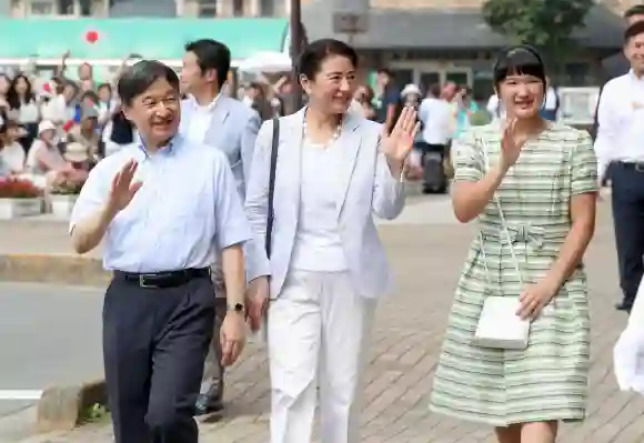Japanese Emperor Naruhito, Empress Masako, and their daughter Princess Aiko wave to the crowd after arriving in eastern Japan, August 19, 2019.