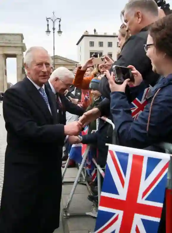 King Charles III talks to fans in front of the Brandenburg Gate