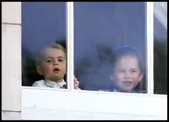 Prince Louis and Princess Charlotte look out the window of Buckingham Palace as they join HM Queen Elizabeth II accompanied by other members of the Royal Family attends Trooping the Colour in central London.