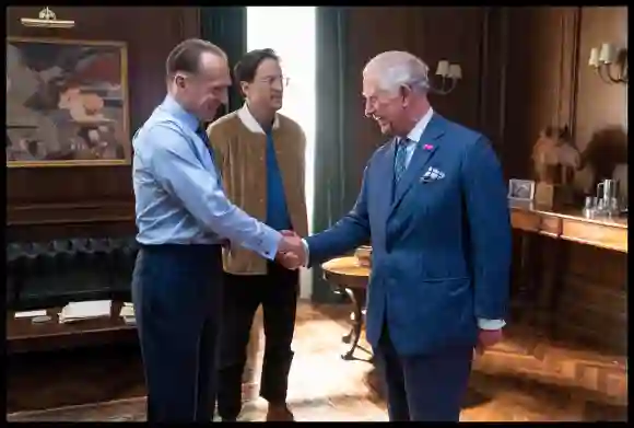 Prince Charles greets Ralph Fiennes as he tours the set of the 25th James Bond Film on June 20, 2019.